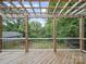 A covered back deck overlooks the backyard which has plenty of mature trees at 430 Edgegreen Dr, Charlotte, NC 28217