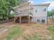 A view of the back of the home with a deck and access to the basement at 430 Edgegreen Dr, Charlotte, NC 28217
