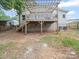 Back of the house shows an elevated deck with stairs and access to the basement at 430 Edgegreen Dr, Charlotte, NC 28217