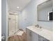 Light blue bathroom featuring a sleek glass shower and modern vanity at 430 Edgegreen Dr, Charlotte, NC 28217