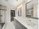 Bright bathroom with double sink vanity, modern fixtures, and a glass-enclosed shower at 430 Edgegreen Dr, Charlotte, NC 28217