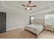 Cozy bedroom with hardwood floors, a ceiling fan, recessed lighting, and a large bed at 430 Edgegreen Dr, Charlotte, NC 28217