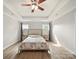 Bright bedroom with hardwood floors, a ceiling fan, recessed lighting, and a large bed with matching nightstands at 430 Edgegreen Dr, Charlotte, NC 28217