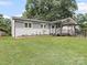 Charming one-story home featuring a well-manicured lawn, gray brick, and an inviting covered porch at 430 Edgegreen Dr, Charlotte, NC 28217