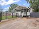 Inviting home with fenced yard and charming covered entry featuring gray decking and white railings at 430 Edgegreen Dr, Charlotte, NC 28217