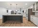 An open gourmet kitchen with island, stainless appliances, granite counters, and hardwood floors at 430 Edgegreen Dr, Charlotte, NC 28217