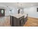 Charming kitchen island features granite countertops, a microwave, and farmhouse sink at 430 Edgegreen Dr, Charlotte, NC 28217