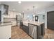 Well-lit kitchen with stainless steel appliances, farmhouse sink and granite counters at 430 Edgegreen Dr, Charlotte, NC 28217
