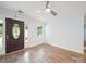A bright living room features laminated wood flooring, a decorative front door and a large window at 430 Edgegreen Dr, Charlotte, NC 28217