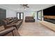Inviting living room includes a fireplace, wood flooring and modern ceiling fan at 430 Edgegreen Dr, Charlotte, NC 28217