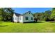 Exterior rear corner view of the home with a well-kept lawn at 4501 E Highway 27 Hwy, Iron Station, NC 28080