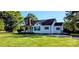Exterior view of home with green lawn, black shutters, and front porch at 4501 E Highway 27 Hwy, Iron Station, NC 28080