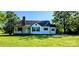 Picture of a quaint home with a charming brick chimney and a spacious lawn at 4501 E Highway 27 Hwy, Iron Station, NC 28080
