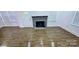 Bright living room with a gray brick fireplace and modern flooring at 4501 E Highway 27 Hwy, Iron Station, NC 28080