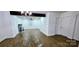 Open-concept living room boasts wood floors and a charming brick fireplace at 4501 E Highway 27 Hwy, Iron Station, NC 28080