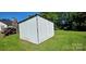 Simple metal outbuilding for storage, set in a grassy yard, with a classic, functional design at 4501 E Highway 27 Hwy, Iron Station, NC 28080