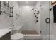 White tiled walk-in shower with a built-in seat and glass door showcasing modern design at 460 E 33Rd St, Charlotte, NC 28205