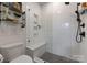 Walk-in shower with white subway tile, built-in seat, and gray hexagon tile floor at 460 E 33Rd St, Charlotte, NC 28205