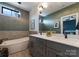 Luxurious bathroom with double vanity, soaking tub, and elegant light fixture at 460 E 33Rd St, Charlotte, NC 28205