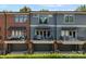 Charming townhome exterior with brick accents, private balconies, and attached garages at 460 E 33Rd St, Charlotte, NC 28205