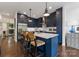 Chic blue kitchen features a center island with seating, modern appliances, and ample cabinet space at 460 E 33Rd St, Charlotte, NC 28205