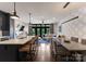 Open-concept kitchen features an island with barstool seating, dining area, and a view of the living room at 460 E 33Rd St, Charlotte, NC 28205