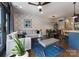 Bright living room with modern furnishings including a gray couch, blue rug, and open floorplan to dining area at 460 E 33Rd St, Charlotte, NC 28205