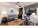 Inviting living room featuring a stylish sofa, patterned wallpaper, a ceiling fan, and built-in shelving at 460 E 33Rd St, Charlotte, NC 28205