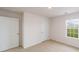 Neutral bedroom features two doors, a window with lawn view, and carpet at 462 Janie Cir # 100, Newton, NC 28658
