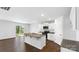 Bright kitchen with granite island, stainless steel appliances, and sliding glass doors to backyard at 462 Janie Cir # 100, Newton, NC 28658