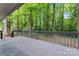 Spacious back deck with black metal railings overlooking a private wooded backyard at 5534 Great Wagon Rd, Charlotte, NC 28215
