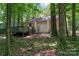 Rear view of yellow home with deck and wood surroundings at 5534 Great Wagon Rd, Charlotte, NC 28215