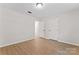 A bright bedroom features light-colored walls and flooring, enhancing a spacious feel with a ceiling light at 5534 Great Wagon Rd, Charlotte, NC 28215