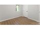 A cozy bedroom featuring a window with natural light and wood-look floors at 5534 Great Wagon Rd, Charlotte, NC 28215