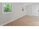 Bedroom features wood-look floors, 2 windows for natural light and an exterior door at 5534 Great Wagon Rd, Charlotte, NC 28215