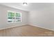 Bedroom with window for natural light, neutral walls, and wood-look flooring at 5534 Great Wagon Rd, Charlotte, NC 28215