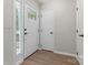 Bright entryway featuring a decorative front door, white trim, and wood-look flooring at 5534 Great Wagon Rd, Charlotte, NC 28215