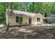 The exterior of this charming home features a well-manicured lawn, lots of trees, and a lovely facade at 5534 Great Wagon Rd, Charlotte, NC 28215