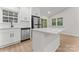 Bright kitchen features white cabinets, quartz countertops, stainless steel appliances, and an island at 5534 Great Wagon Rd, Charlotte, NC 28215