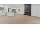 Spacious living room with fireplace, ample windows, stainless steel appliances, and stylish flooring at 5534 Great Wagon Rd, Charlotte, NC 28215