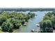 Scenic aerial shot of a waterfront property with boat docks surrounded by lush trees and a peaceful lake at 584 Williamson Rd, Mooresville, NC 28117