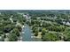 Aerial view of the waterfront property at 584 Williamson Rd surrounded by lush greenery at 584 Williamson Rd, Mooresville, NC 28117