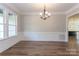 Elegant dining area with hardwood floors, wainscoting, and contemporary lighting at 584 Williamson Rd, Mooresville, NC 28117