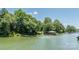 Picturesque waterfront view with docks and a gazebo surrounded by lush greenery and calm waters at 584 Williamson Rd, Mooresville, NC 28117