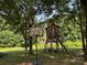 Backyard with a basketball hoop and custom treehouse, perfect for outdoor activities and recreation at 6616 Love Mill Rd, Monroe, NC 28110