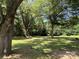 Expansive backyard with mature trees providing ample shade and a lush green lawn at 6616 Love Mill Rd, Monroe, NC 28110