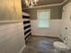 Bathroom featuring a toilet, window, and updated fixtures for a spa-like experience at 6616 Love Mill Rd, Monroe, NC 28110