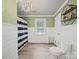 Inviting bathroom featuring wainscoting, a window, and a black and white striped shower curtain at 6616 Love Mill Rd, Monroe, NC 28110