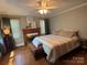 Comfortable bedroom with a decorative fireplace, ceiling fan, and natural light creates a relaxing space at 6616 Love Mill Rd, Monroe, NC 28110