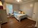 Bright bedroom with hardwood floors and light blue walls, creating a cozy and inviting atmosphere at 6616 Love Mill Rd, Monroe, NC 28110